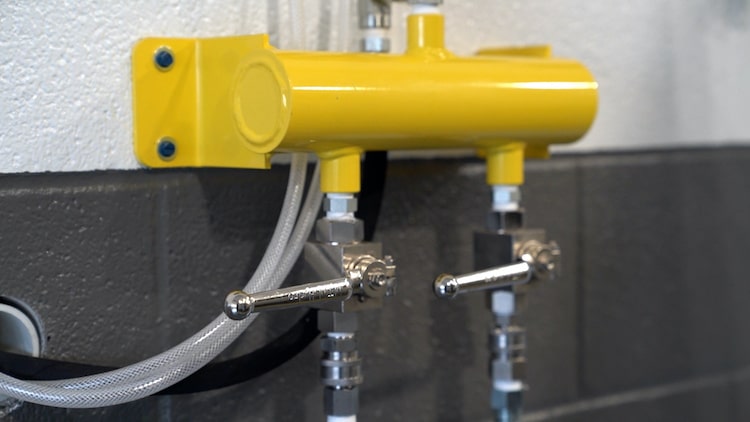Undercarriage wash system control valves in a fleet wash bay